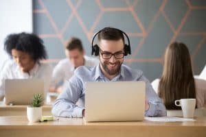 Coworkers watching a video from their laptops. Shows why and how you can introduce video into your employee engagement strategy with SGA