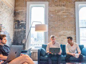 Potential employees engaged by employer brand video ahead of their interview in a modern office