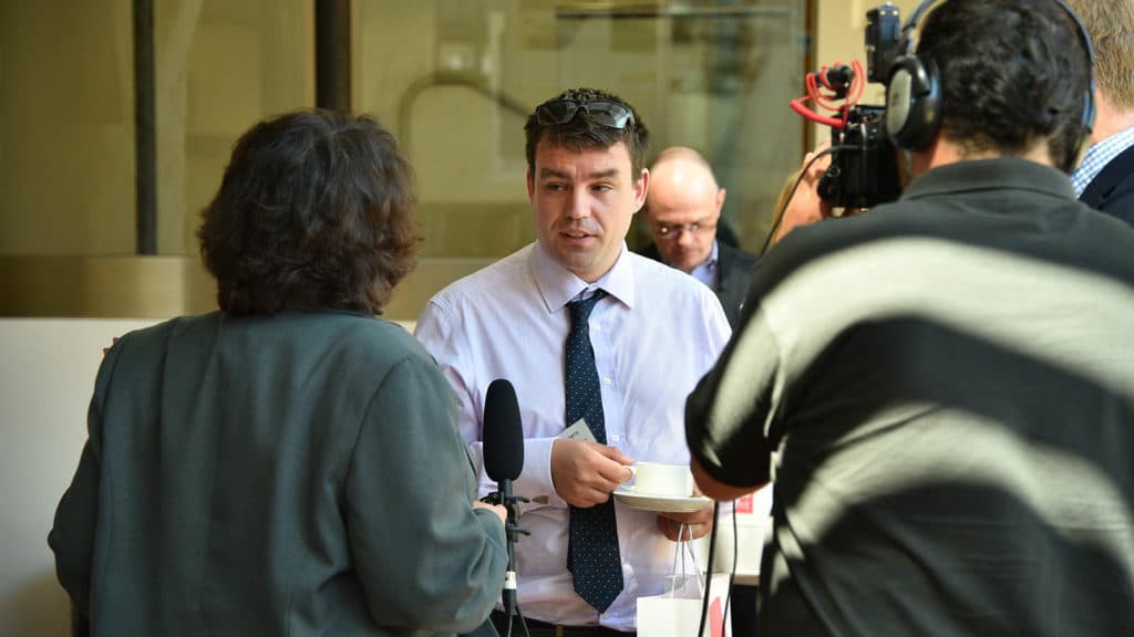 Businessmen being interviewed on video